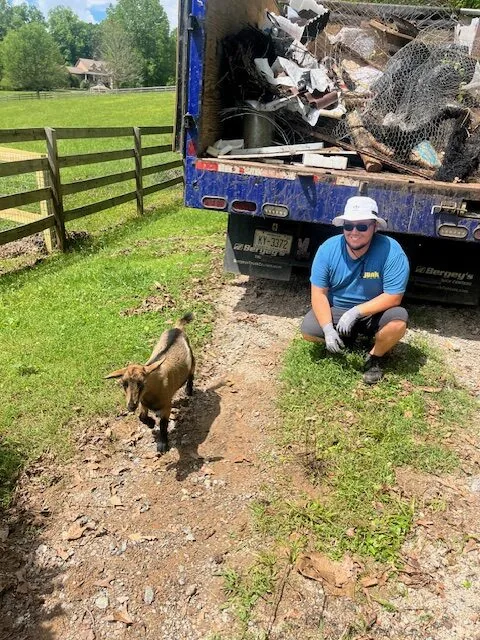 A Junk Punk crew member with a goat at a job