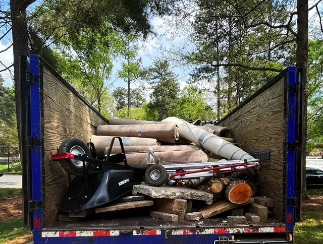 A full load: carpet, a grill and old lumber